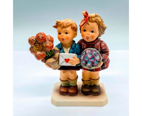 Signed and dated hand painted group figure of a boy and girl with flowers. Goebel Hummel backstamp. HUM 416. Issued: c. 1980s