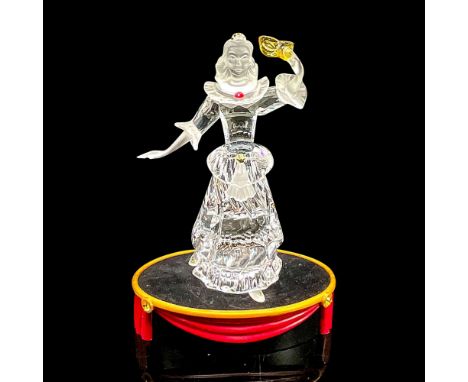 Brilliant clear crystal Harlequin with arm raised holding mask. Red, yellow and blue accent crystals. Satin head and arms. Sw