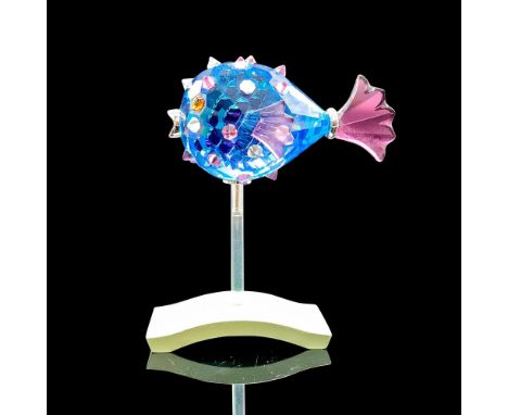 Depicts a blue crystal blowfish with clear and purple crystals for the spikes as well as purple fins. Swarovski backstamp. Th