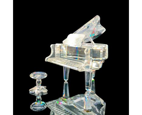 Depicts a clear crystal grand piano with a crystal seat. Swarovski backstamp. This item has its original box. Dimensions of t