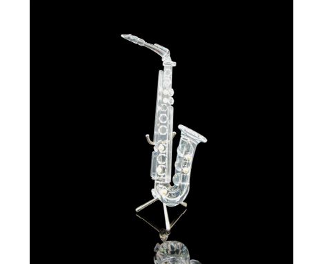 Clear faceted body with simulated pearls on hole covers. Figural has stand for instrument. Swarovski backstamp. 7477 000 007.