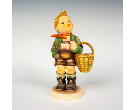Hand painted in matte finish modeled as a young German boy carrying a basket. M. I. Hummel impressed backstamp. Goebel backst