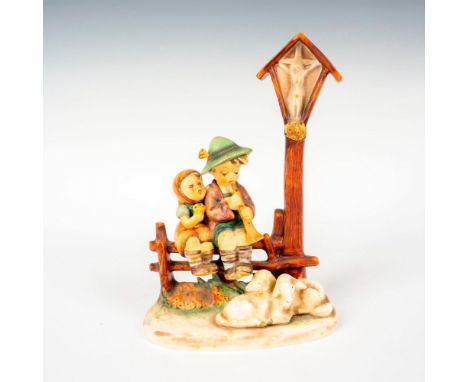 Hand painted in matte finish modeled as two kids sitting on a fence with two lambs resting by their feet. M. I. Hummel impres