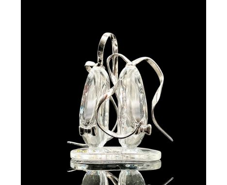 Adorable faceted miniature crystal figurine modeled as a pair of upright ballet slippers with flowing silver tone ribbons and