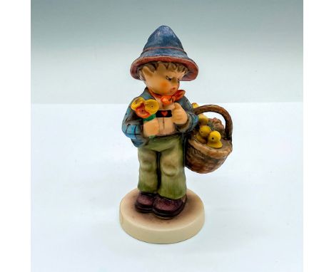Hand painted figure of a young boy with a basket of chicks and bouquet of flowers. Goebel Hummel backstamp. HUM 378. Issued: 