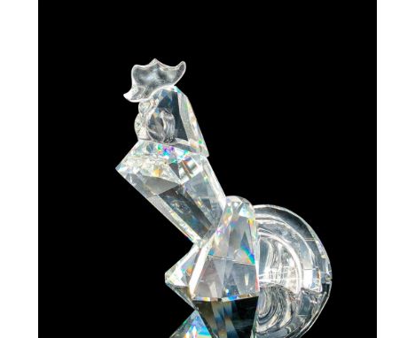 Depicts a clear crystal rooster sitting down and chest out. Swarovski backstamp. This item has its original box. Dimensions o