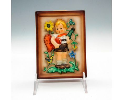 Raised, hand painted design of child holding heart with flowers and bird around her. Hummel impressed mark. Goebel backstamp.