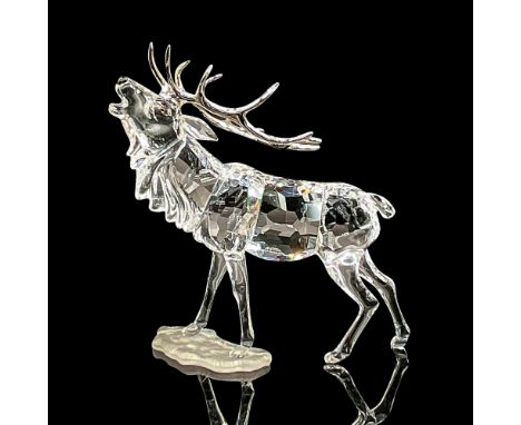 Brilliant clear crystal figure of a mighty elk on a satin base looking upwards. Rhodium antlers. Model number 291431. Swarovs