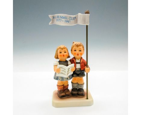 M.I. Hummel Club exclusive edition 1996/97. Boy is holding M.I. Hummel Club 1977 - 1997 flag. Girl holding songbook. Goebel b