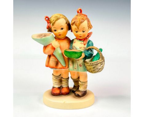 Hand painted in matte finish modeled as a young boy and girl carrying a hand full of goodies. M. I. Hummel impressed backstam