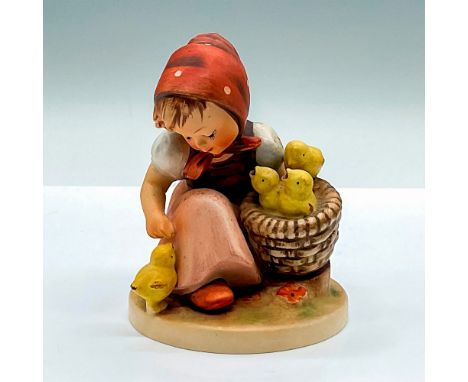 Hand painted figure of a young girl with a basket of chicks. Goebel Hummel backstamp. Issued: c. 1960-1972Dimensions: 3.75"L 
