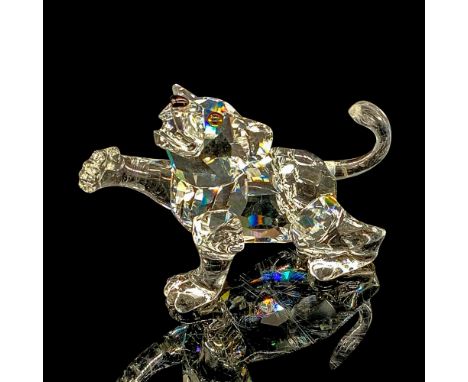 Part of the African Wildlife collection. Miniature lion figurine made of clear crystal for the head and the body. The right p