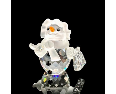 Adorable faceted crystal figurine modeled as a smiling snow woman holding a little purse. Black gem buttons, orange nose, and