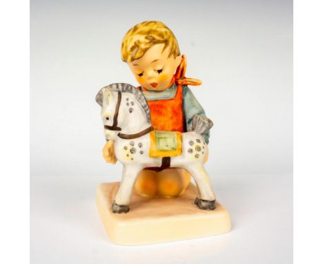 Hand painted in matte finish modeled as a young boy playing with his rocking horse. M. I. Hummel impressed backstamp. Goebel 