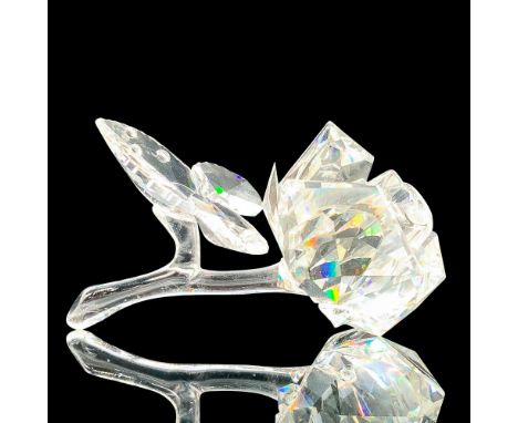 Depicts a clear rose blooming with its stem and a group of three leaves. Swarovski backstamp. This item has its original box.