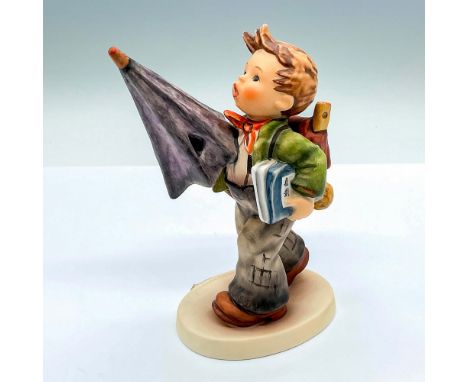 Hand painted figure of a young boy looking with a large umbrella. Goebel Hummel backstamp. Issued: c. 1979-1990Dimensions: 4.