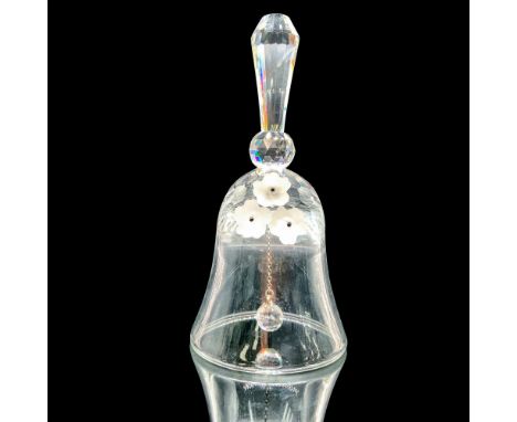 This figurine is hand bell made of crystal with three fogged crystal flowers on the front. Swarovski backstamp. This item has