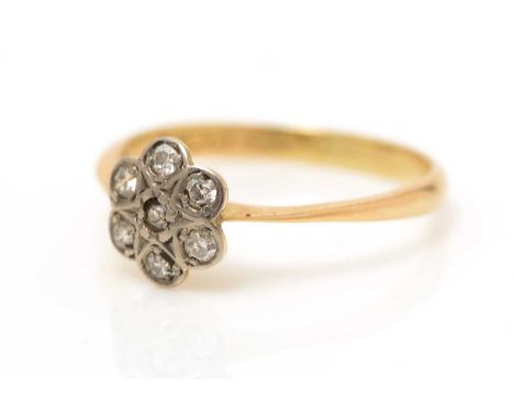 A diamond cluster ring, set with seven eight-cut diamonds, the yellow metal shank stamped '18ct', ring size L, 1.6g gross. 