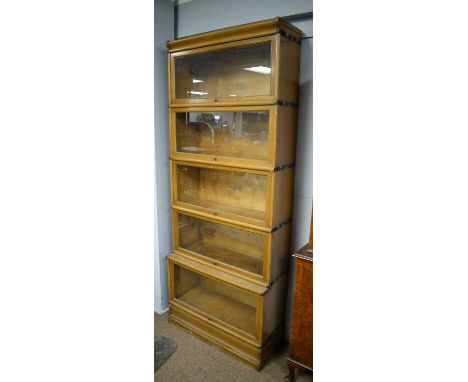 Globe Wernicke: a light oak five-tier sectional bookcase, with glazed dust covers, 87 x 210cms high.