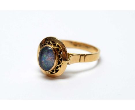 An opal ring, the yellow metal mount and shank stamped 'K18', ring size N, 4.0g gross. 