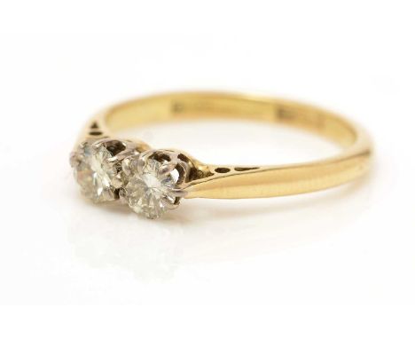 A two stone diamond ring, the brilliant-cut diamonds weighing a total of approximately 0.40 carats, the yellow metal shank st