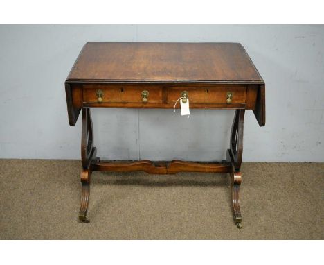 A Georgian style walnut sofa table, the rectangular double flap top above two frieze drawers, raised on lyre pattern supports