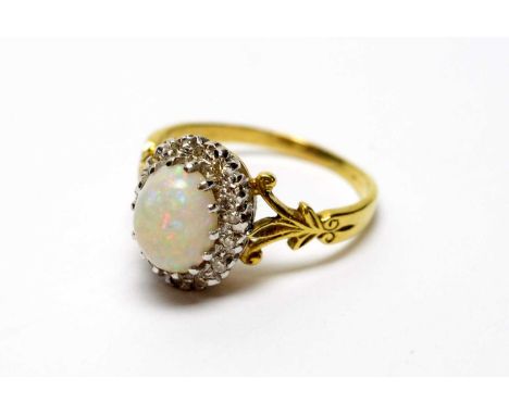 An opal and diamond cluster ring, the oval opal cabochon surrounded by eight-cut diamonds, on yellow metal shank, ring size Q