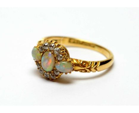 An opal and diamond ring, the three opal cabochons with old cut diamonds in a cluster formation, on 18ct yellow gold shank, r