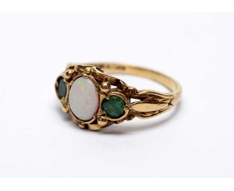 An opal and emerald ring, on 9ct yellow gold shank, ring size M, 2.9g gross. 