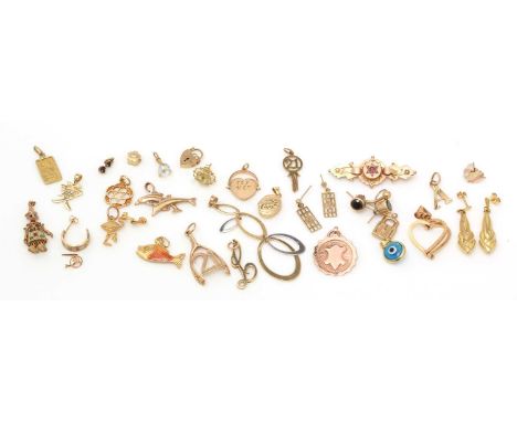 A selection of 9ct yellow gold and yellow metal charms and pendants, including: a .999 fine gold pendant; an enamel fish patt