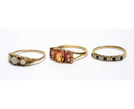 Three gemstone rings, one mystic topaz, one sapphire and diamond, and the third opal and sapphire, all on 9ct gold shanks, 6.