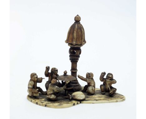 A late 19th Century Japanese ivory okimono, carved as five clothed monkeys holding various tools, one smoking a pipe, signed,