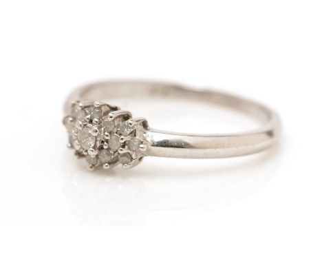 A diamond cluster ring, on 9ct white gold shank, ring size L, 1.8g gross. 
