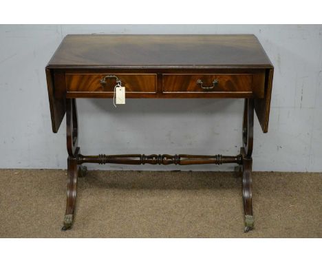 A reproduction mahogany sofa table, fitted two frieze drawers and two false drawers above lyre-pattern supports, 88 x 50 x 73