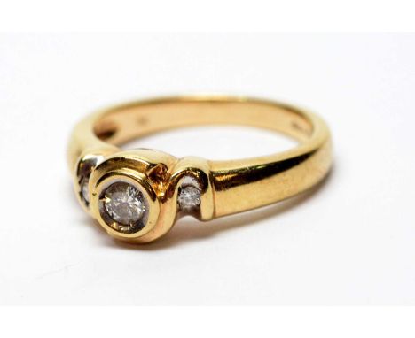 A three stone diamond ring, on 9ct yellow gold shank, ring size M, 4.2g gross.