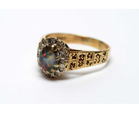 An opal and diamond cluster ring, the oval opal cabochon surrounded by brilliant cut diamonds, on 9ct yellow gold shank, ring