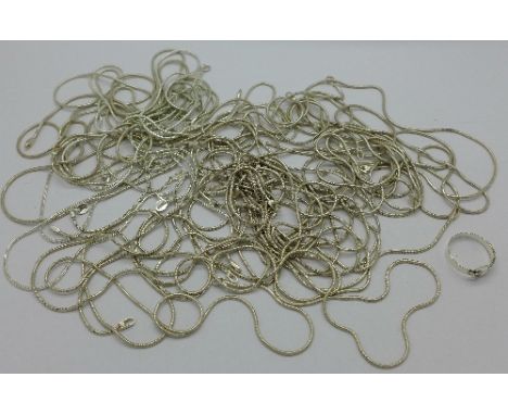 Seventeen silver chains and a silver ring, 99g, chains lacking fasteners