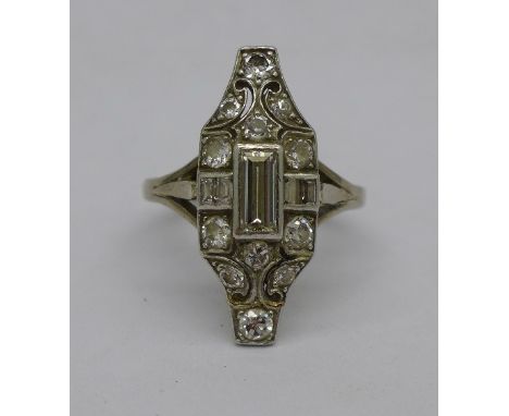 An 18ct white gold, Art Deco ring, set with baguette centre stone, four other baguette cut diamonds and twelve brilliant cut 