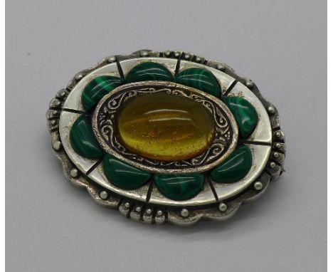 A Celtic style silver and malachite set brooch