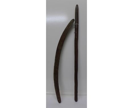 An Aboriginal boomerang and digging stick with long vertical incised grooves