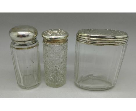 Two silver topped dressing table jars and one other