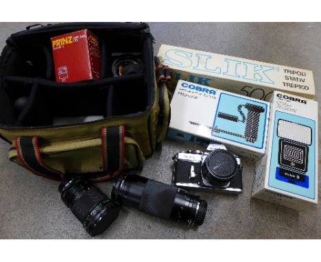 A box of camera equipment including a Minolta XE-1 camera, two lenses including Hanimex 72mm 20cm, Miranda 75-300mm, a silk t