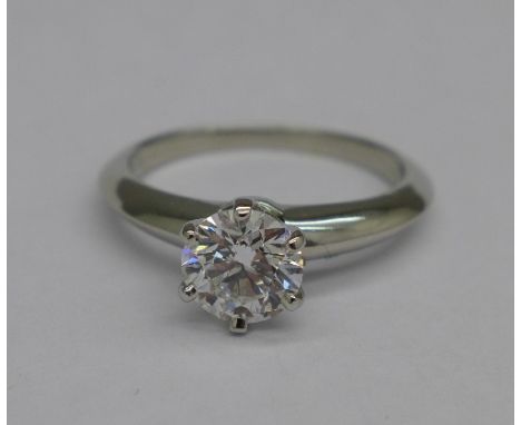 A Tiffany diamond ring, 0.86ct solitaire diamond in a platinum shank, AGI diamond grading report 25th February 2016:- diamond