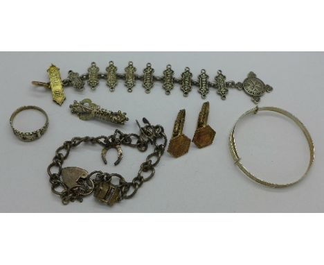 A Victorian silver Best Wishes brooch, a silver charm bracelet, a silver St. Johns medal, a ring, a bangle and a pair of cuff
