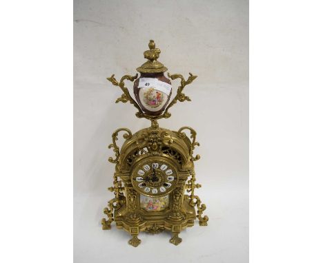 CONTINENTAL BRASS CASED AND PORCELAIN MOUNTED MANTEL CLOCK