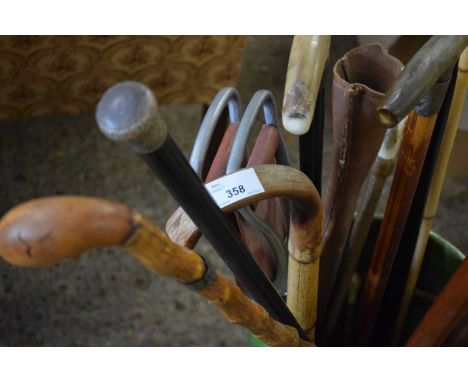 GREEN GLAZED STICK STAND CONTAINING A VARIETY OF WALKING STICKS