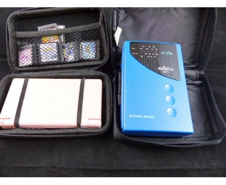 A boxed Nintendo DS and a hand held radio / cassette recorder