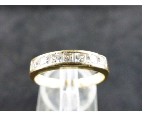 18 ct gold ring with seven channel set stones. Size O.