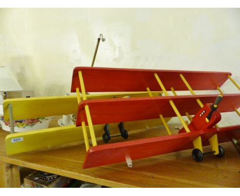 Two unusual childrens wall mounted shelves in the form of vintage aeroplanes