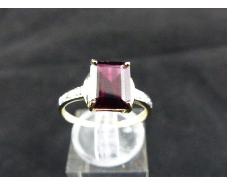 9 ct gold garnet ring with diamond shoulders. Size O.